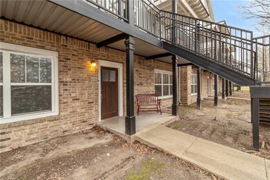 Doorway to property featuring a patio area and bri