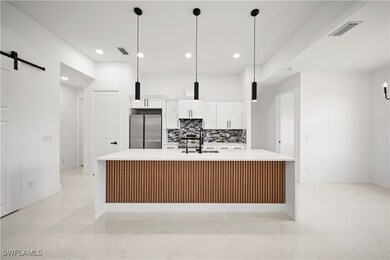 Kitchen featuring stainless steel fridge, a barn d