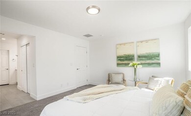 Bedroom with carpet floors and multiple windows