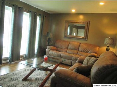 Wall of windows at front of living room.
