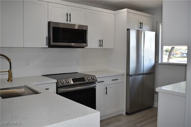 Kitchen with white cabinets, stainless steel appli