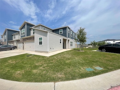 View of side of home with a garage, driveway, and