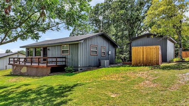 Rear view of property featuring a yard, central ai