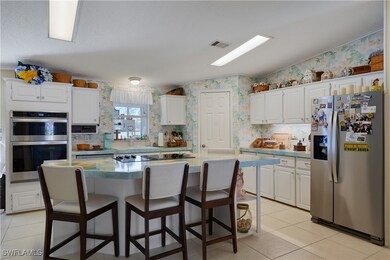 Kitchen with visible vents, a kitchen island, wall