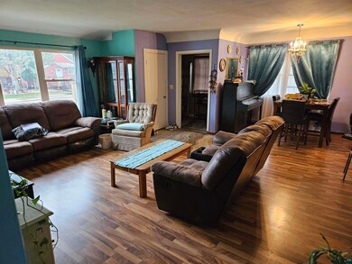 Living room featuring a chandelier and dark hardwo
