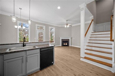Kitchen with ornamental molding, a fireplace, dish