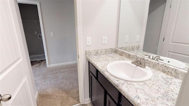 Bathroom with vanity and baseboards