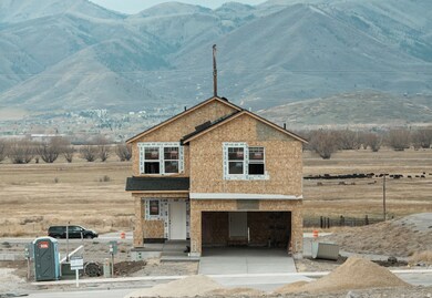 View of front of home with a porch, a mountain view, concrete driveway, and an attached garage