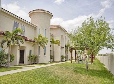 View of exterior entry with a tiled roof and stucco siding