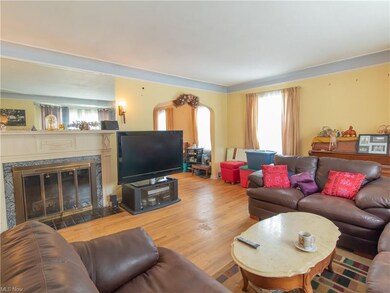 The living room has hardwood floors and a fireplac