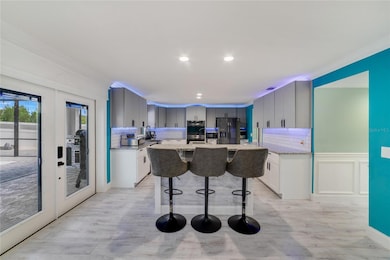 Take note of the modern LAMINATE WOOD FLOORS as you follow the natural flow into the large family room and kitchen!