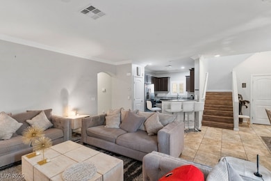 Living room with arched walkways, crown molding, s
