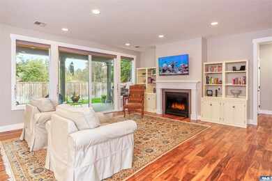 In warm weather the floor-to-ceiling sliding doors open to a covered patio, with a gas-piped BBQ