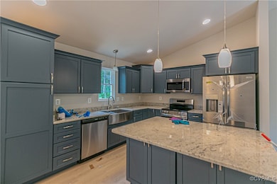 Kitchen with stainless steel appliances, vaulted c