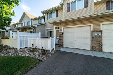 The unit has an attached garage and a patio with privacy fencing.