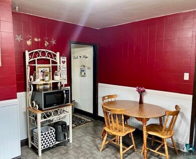 Dining space featuring dark parquet floors
