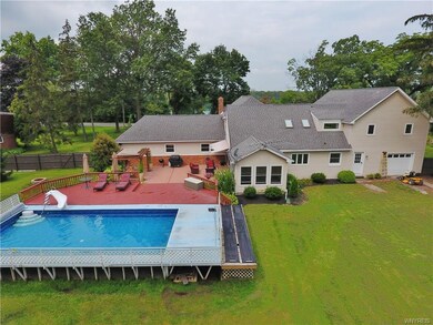 Beautiful fenced rear yard with pool and deck.