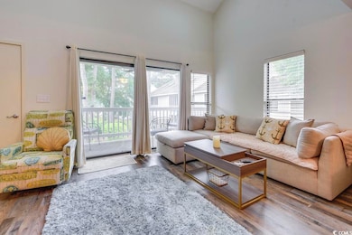 Living room featuring high vaulted ceiling, LVP-ty