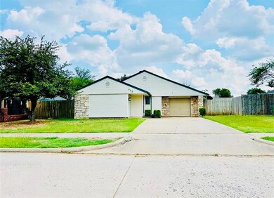 Ranch-style house with stone siding, concrete driveway, and a garage