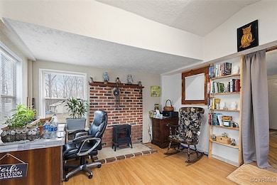 Office space with lofted ceiling, a textured ceili