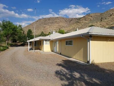 Rear view of property with a mountain view and a metal roof