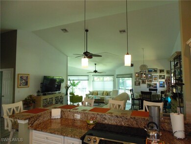 Kitchen with pendant lighting, stone countertops,