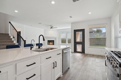 Kitchen with ceiling fan, stainless steel applianc