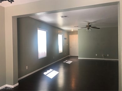 Spare room with dark wood-style floors, baseboards