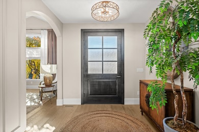 Foyer featuring wood finished floors and arched walkways