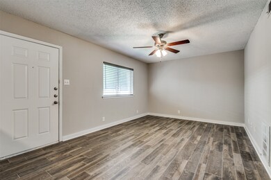 Foyer featuring wood finish floors, a textured ceiling, and a ceiling fan