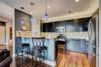 Full-sized kitchen is equipped with stainless stee