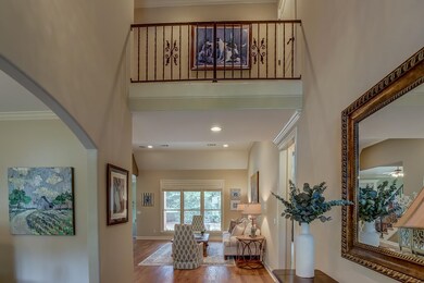 Foyer entrance featuring ceiling fan, crown moldin