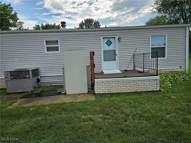 Rear view of property featuring a yard