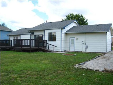 Back of house. Beyond the extra paved parking besi