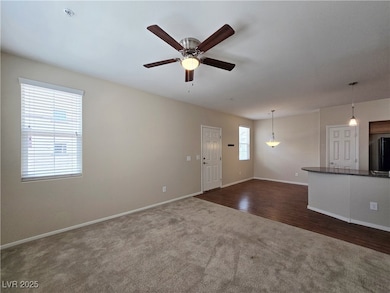 Unfurnished living room with dark colored carpet,