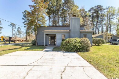 Mid-century home featuring a chimney and a front l