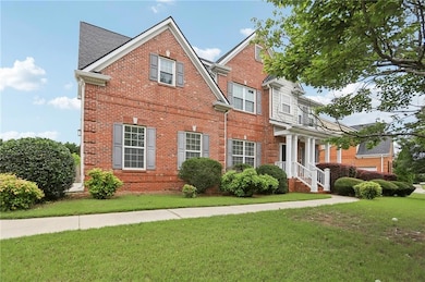 View of front of house with brick siding and a front lawn