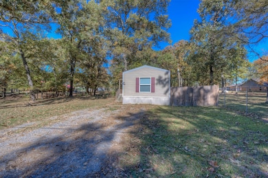 View of side of property featuring view of scattered trees