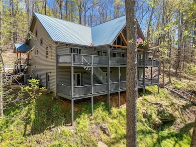 Rear view of property featuring central AC, stairw