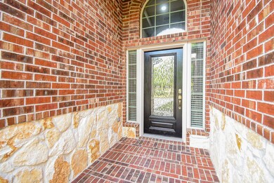This entryway features a welcoming black door with