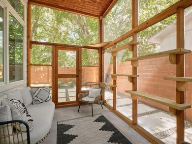 Sunroom featuring a wall of windows and wooden ceiling
