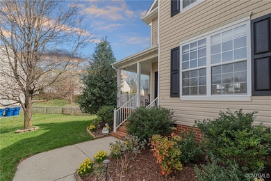 Doorway to property with a lawn and a porch