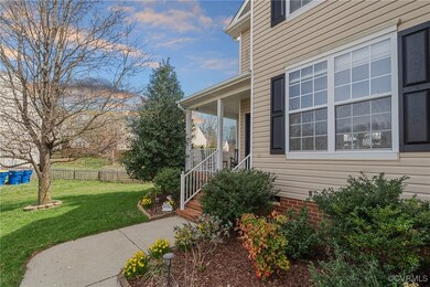 Doorway to property with a lawn and a porch