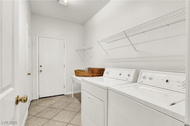 Washroom featuring washing machine and dryer and light tile patterned floors, big laundry closet !