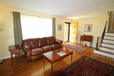 The spacious living room has a bright neutral deco