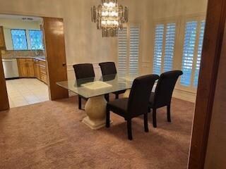 Dining room with light carpet and a notable chande