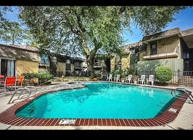 Community pool with fence, a patio, and a residential view