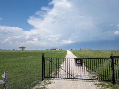 View of gate featuring a yard, fence, and a rural