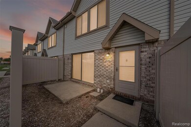 Exterior entry at dusk with brick siding