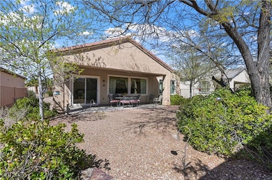 Rear view of property featuring stucco siding and
